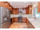 Well-equipped kitchen with stainless steel appliances and wooden cabinetry at 220 Garden S Cir, Dunedin, FL 34698