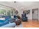 Stylish living room featuring hardwood floors, a comfortable seating area, and lots of natural light at 220 Garden S Cir, Dunedin, FL 34698