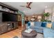 Bright and airy living room featuring a modern ceiling fan and a comfortable seating area at 220 Garden S Cir, Dunedin, FL 34698