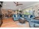 Inviting living room with hardwood floors, neutral walls, and a comfortable sectional sofa at 220 Garden S Cir, Dunedin, FL 34698