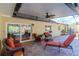 Relaxing screened-in patio with comfortable seating, a ceiling fan, and access to the pool area for outdoor enjoyment at 220 Garden S Cir, Dunedin, FL 34698