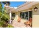 Cozy covered patio with wooden rocking chairs, tile flooring, and bright natural lighting at 220 Garden S Cir, Dunedin, FL 34698