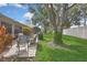 Lush backyard featuring a patio, mature trees, and manicured lawn, perfect for relaxation at 2343 Hidden Trail Dr, Spring Hill, FL 34606