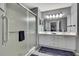 Bathroom featuring a glass-enclosed shower and a double sink vanity at 2343 Hidden Trail Dr, Spring Hill, FL 34606