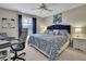 Cozy bedroom with a queen bed, a bright window, and a comfortable desk area at 2343 Hidden Trail Dr, Spring Hill, FL 34606
