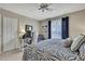 Bright bedroom featuring a desk area, a ceiling fan, and a large window at 2343 Hidden Trail Dr, Spring Hill, FL 34606