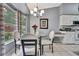 Cozy breakfast nook with backyard view and chandelier lighting features table for four at 2343 Hidden Trail Dr, Spring Hill, FL 34606