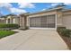 Well-maintained home exterior with two-car garage, driveway, and manicured landscaping at 2343 Hidden Trail Dr, Spring Hill, FL 34606