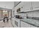 Well-equipped kitchen featuring stainless steel appliances, granite countertops, and a cozy dining nook at 2343 Hidden Trail Dr, Spring Hill, FL 34606
