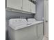 Functional laundry room equipped with white appliances and ample storage at 2343 Hidden Trail Dr, Spring Hill, FL 34606
