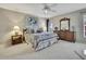 Spacious primary bedroom boasts natural light, plush carpeting, and ensuite bathroom at 2343 Hidden Trail Dr, Spring Hill, FL 34606