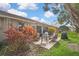 Outdoor patio area with a brick surface, seating, colorful foliage, and a grill at 2343 Hidden Trail Dr, Spring Hill, FL 34606