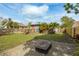 Expansive backyard featuring a gravel fire pit, tropical foliage, and a shed with a wooden deck at 2454 15Th N Ave, St Petersburg, FL 33713
