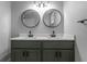 Modern bathroom featuring double sinks, sleek black faucets, round mirrors, and contemporary lighting fixtures at 2454 15Th N Ave, St Petersburg, FL 33713