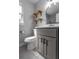 Stylish bathroom features gray vanity, modern fixtures, and two rustic wood shelves at 2454 15Th N Ave, St Petersburg, FL 33713