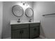 Bathroom with double vanity, modern fixtures, and round mirrors with decorative lighting at 2454 15Th N Ave, St Petersburg, FL 33713