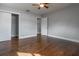 Spacious bedroom featuring pristine gray walls, sleek ceiling fan, and elegant hardwood floors at 2454 15Th N Ave, St Petersburg, FL 33713