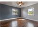 Bedroom showcasing hardwood floors, a ceiling fan, and two windows for ample natural light at 2454 15Th N Ave, St Petersburg, FL 33713