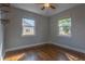 Cozy bedroom featuring hardwood floors, a ceiling fan, and two windows offering natural light at 2454 15Th N Ave, St Petersburg, FL 33713