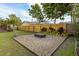 Backyard features a gravel fire pit area, manicured lawn and colorful foliage at 2454 15Th N Ave, St Petersburg, FL 33713