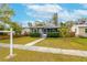 Charming single-story home with gray siding, decorative shutters, manicured hedges and a walkway leading to the front door at 2454 15Th N Ave, St Petersburg, FL 33713