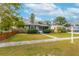 Charming single-story home with gray siding, decorative shutters, manicured hedges and a walkway leading to the front door at 2454 15Th N Ave, St Petersburg, FL 33713