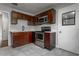 This kitchen features stainless steel appliances, dark wood cabinets, light countertops, and gray tile floors at 2454 15Th N Ave, St Petersburg, FL 33713