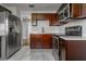 Well-equipped kitchen boasts dark wood cabinets, stainless appliances and stylish countertops at 2454 15Th N Ave, St Petersburg, FL 33713