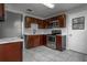 Modern kitchen features stainless steel appliances and dark wood cabinetry, complemented by tile flooring at 2454 15Th N Ave, St Petersburg, FL 33713