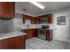 Modern kitchen features stainless steel appliances and dark wood cabinetry, complemented by tile flooring at 2454 15Th N Ave, St Petersburg, FL 33713