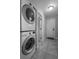 Functional laundry room with stackable washer and dryer plus tile flooring and back door access at 2454 15Th N Ave, St Petersburg, FL 33713
