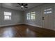 The living room has hardwood floors, a ceiling fan and light gray walls with white trim around the windows and doors at 2454 15Th N Ave, St Petersburg, FL 33713