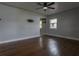 The living room has hardwood floors, a ceiling fan and light gray walls with white trim around the windows and doors at 2454 15Th N Ave, St Petersburg, FL 33713