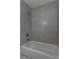 Neutral bathroom boasts a shower with large gray tile and sleek fixtures at 2454 15Th N Ave, St Petersburg, FL 33713