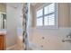 Soaking tub with a floral shower curtain in the main bathroom offers great natural light at 2904 Bear Oak Dr, Valrico, FL 33594