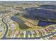 Aerial view of a residential area with lake views, tree lined streets, and neatly arranged homes at 31101 Wrencrest Dr, Wesley Chapel, FL 33543