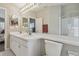 Bright bathroom featuring double sinks, ample counter space, and a large vanity mirror at 31101 Wrencrest Dr, Wesley Chapel, FL 33543