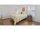 Bright bedroom featuring wood floors, a queen bed, and closet at 31101 Wrencrest Dr, Wesley Chapel, FL 33543