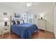 Bright bedroom with a brass bed, white walls, wood floors, and vaulted ceilings at 31101 Wrencrest Dr, Wesley Chapel, FL 33543