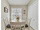 Cozy breakfast nook with white table, chairs, and bright window shutters for a welcoming space at 31101 Wrencrest Dr, Wesley Chapel, FL 33543