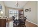 Formal dining room featuring hardwood floors, a large window, and a classic chandelier for elegant gatherings at 31101 Wrencrest Dr, Wesley Chapel, FL 33543