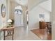 Bright foyer showcasing neutral tile flooring and an elegant light fixture at 31101 Wrencrest Dr, Wesley Chapel, FL 33543