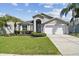 Charming single Gathering home with a well maintained lawn and beautiful Florida landscaping at 31101 Wrencrest Dr, Wesley Chapel, FL 33543