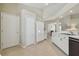 Bright kitchen with white cabinets and modern appliances with views to dining area at 31101 Wrencrest Dr, Wesley Chapel, FL 33543