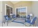 Covered lanai with comfortable seating, providing a relaxing outdoor living space with a view of the pool at 31101 Wrencrest Dr, Wesley Chapel, FL 33543