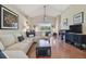Spacious living room with vaulted ceiling, ample seating, and view of lush backyard at 31101 Wrencrest Dr, Wesley Chapel, FL 33543