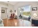 Bright living room with hardwood floors, access to outdoor pool, and elegant furnishings at 31101 Wrencrest Dr, Wesley Chapel, FL 33543