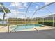 Screened pool with lake view, ample decking and patio seating at 31101 Wrencrest Dr, Wesley Chapel, FL 33543
