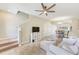 Open-concept living room with tile floors, staircase, and view of the dining area at 31229 Claridge Pl, Wesley Chapel, FL 33543