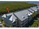 Stunning waterfront condo featuring a durable metal roof and balconies overlooking the serene river at 3230 Mangrove Point Dr, Ruskin, FL 33570